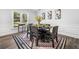 Formal dining room with modern decor, wainscoting, a decorative rug, and sunlit windows at 745 Princeton Mill Run, Marietta, GA 30068