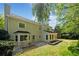 Rear exterior of home showcasing a patio area and a lush, private backyard setting at 745 Princeton Mill Run, Marietta, GA 30068