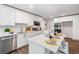 Contemporary kitchen with white cabinetry, a center island with seating, stainless appliances, and ample counter space at 745 Princeton Mill Run, Marietta, GA 30068