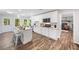 Modern white kitchen featuring an island with seating, updated appliances, and abundant natural light at 745 Princeton Mill Run, Marietta, GA 30068