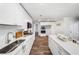 Modern kitchen features sleek white cabinets, an island with seating, and stainless-steel appliances at 745 Princeton Mill Run, Marietta, GA 30068