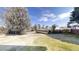 Expansive backyard featuring a lush lawn, mature trees, and partial fencing at 921 Dunagan Way, Lawrenceville, GA 30045