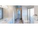 Bathroom with grey tile floor, shower stall, and white vanity with white cabinets at 921 Dunagan Way, Lawrenceville, GA 30045