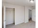 A bedroom showcasing an open closet, neutral carpet, and a ceiling light fixture at 921 Dunagan Way, Lawrenceville, GA 30045