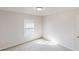 An empty bedroom with carpeted floors and a window providing natural light at 921 Dunagan Way, Lawrenceville, GA 30045