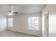 Bright bedroom featuring carpeted floor, ceiling fan, and two windows with natural light at 921 Dunagan Way, Lawrenceville, GA 30045