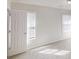 Sunlit bedroom featuring bright white walls, plush carpet, and windows with white blinds at 921 Dunagan Way, Lawrenceville, GA 30045