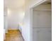 Walk-in closet with built-in shelving and nearby bathroom featuring white vanity and tile floor at 921 Dunagan Way, Lawrenceville, GA 30045