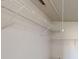Walk-in closet features white walls, shelving, and overhead ventilation at 921 Dunagan Way, Lawrenceville, GA 30045