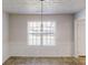 Dining room featuring wainscoting and a modern pendant light fixture above dining space at 921 Dunagan Way, Lawrenceville, GA 30045