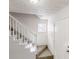 Bright entryway showcasing staircase with white railing and a window for natural light at 921 Dunagan Way, Lawrenceville, GA 30045