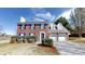 Charming brick home featuring a two-car garage and well-maintained front yard at 921 Dunagan Way, Lawrenceville, GA 30045