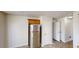 Kitchen area with stainless steel refrigerator and access to an additional room at 921 Dunagan Way, Lawrenceville, GA 30045