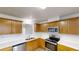 Well-lit kitchen with stainless steel appliances, light countertops, and wood cabinetry at 921 Dunagan Way, Lawrenceville, GA 30045