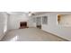 Spacious living room featuring a brick fireplace, ceiling fan and an opening to the kitchen at 921 Dunagan Way, Lawrenceville, GA 30045