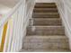 Carpeted staircase with white railing, providing a comfortable transition between floors at 921 Dunagan Way, Lawrenceville, GA 30045