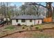 Backyard view showcasing the home's exterior, mature trees, and landscaping at 1090 Indale Sw Pl, Atlanta, GA 30310