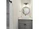Modern bathroom with a stylish vanity, round mirror and tiled shower at 1090 Indale Sw Pl, Atlanta, GA 30310