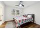 Bedroom featuring ceiling fan, hardwood floors, and a bright window for natural light at 1090 Indale Sw Pl, Atlanta, GA 30310