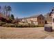 Backyard view of townhouse units featuring well-maintained lawns and landscaping at 2877 Deerwood Sw Dr, Atlanta, GA 30331