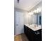 Bathroom featuring a double sink vanity, large mirror, and bright lighting at 2877 Deerwood Sw Dr, Atlanta, GA 30331