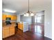 Bright kitchen with wood cabinets, black appliances, and dark wood floors open to the living area at 2877 Deerwood Sw Dr, Atlanta, GA 30331