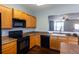 Well-equipped kitchen featuring wood cabinets, modern appliances, and an open view to the living area at 2877 Deerwood Sw Dr, Atlanta, GA 30331