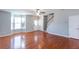 Open-concept living area features hardwood floors, staircase access, and abundant natural light from the bay window at 2877 Deerwood Sw Dr, Atlanta, GA 30331