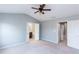 Large primary bedroom with a ceiling fan, neutral carpeting, and ensuite bathroom at 2877 Deerwood Sw Dr, Atlanta, GA 30331