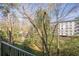 Balcony with trees and a view of a building under a bright sky showcasing outdoor living at 3201 Lenox Ne Rd # 16, Atlanta, GA 30324