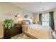 Bedroom featuring hardwood floors, neutral colors, a dresser, and a window with outside views at 3201 Lenox Ne Rd # 16, Atlanta, GA 30324