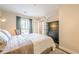 Bedroom featuring hardwood floors, neutral colors, a dresser, and access to an outdoor balcony at 3201 Lenox Ne Rd # 16, Atlanta, GA 30324