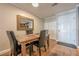 Dining room with wood floors, a wooden table with black chairs, and an entry door with coat hooks at 3201 Lenox Ne Rd # 16, Atlanta, GA 30324