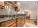 This kitchen has granite counters, wood cabinetry, tile backsplash, and stainless steel faucet at 3201 Lenox Ne Rd # 16, Atlanta, GA 30324