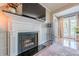 Cozy living room featuring a fireplace with white mantle and dark granite hearth plus a view of the balcony at 3201 Lenox Ne Rd # 16, Atlanta, GA 30324
