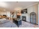 Living room features a fireplace, television, wine rack, and an adjacent kitchen and dining area at 3201 Lenox Ne Rd # 16, Atlanta, GA 30324