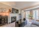 Open floor plan with fireplace, flatscreen television, and French doors to balcony at 3201 Lenox Ne Rd # 16, Atlanta, GA 30324