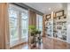 Bright sun room with hardwood floors, built-in shelves, and double doors leading to a balcony at 3201 Lenox Ne Rd # 16, Atlanta, GA 30324