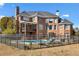 Back of house featuring pool, iron fence and outdoor seating at 100 Annes Ln, Sharpsburg, GA 30277