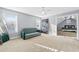 Bright bedroom featuring a sofa, large window, and neutral carpet at 100 Annes Ln, Sharpsburg, GA 30277