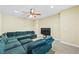 Den featuring a large sectional sofa, ceiling fan, and television at 100 Annes Ln, Sharpsburg, GA 30277