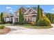 Front of the home showing yard, driveway, and landscaping at 100 Annes Ln, Sharpsburg, GA 30277