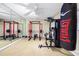 Home gym with mirrored wall and full set of weights and exercise equipment at 100 Annes Ln, Sharpsburg, GA 30277