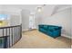 Upstairs loft area with blue couch and natural light at 100 Annes Ln, Sharpsburg, GA 30277