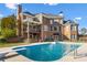 Backyard with a beautiful in-ground swimming pool, a covered porch, and well-maintained landscaping at 100 Annes Ln, Sharpsburg, GA 30277