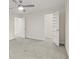 Bedroom featuring gray carpet and a ceiling fan, with doorways to the closet and bathroom at 1261 Lavista Ne Rd # M-4, Atlanta, GA 30324