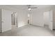 Spacious bedroom with gray carpet, a ceiling fan, and multiple closets, creating an airy and comfortable space at 1261 Lavista Ne Rd # M-4, Atlanta, GA 30324