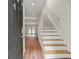 Welcoming entryway featuring new wood-look floors and staircase with wood handrail at 1261 Lavista Ne Rd # M-4, Atlanta, GA 30324