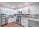 Kitchen with stainless appliances, white cabinets, granite counters, and brick backsplash at 1261 Lavista Ne Rd # M-4, Atlanta, GA 30324