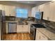 Bright kitchen featuring modern appliances, granite countertops, and white cabinetry at 1261 Lavista Ne Rd # M-4, Atlanta, GA 30324